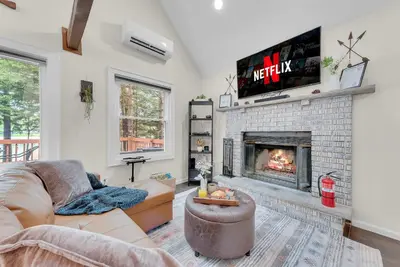 a living room with a couch and a fireplace at Lakefront Hot Tub Kayaks High End Peaceful in Tobyhanna