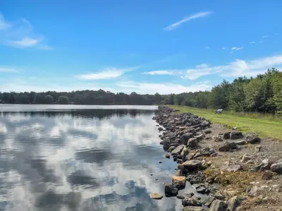 a river with rocks on the shore at Lakefront AC Pool Table Kayaks Refined in Tobyhanna