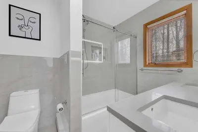 a bathroom with a shower and a toilet and a sink at Lakefront AC Pool Table Kayaks Refined in Tobyhanna