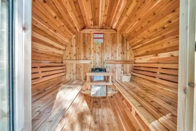 a wooden sauna with a bench in the middle at Massive Log Chalet with Hot Tub in Lakeville