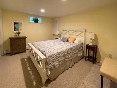 a bedroom with a large bed and a table at The Lookout Lake Masthope Firepit Arcade in Lackawaxen