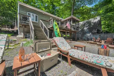 a house with a couch and a tv in front of it at Lake Wallenpaupack Lakefront Private Boat Slip in Greentown