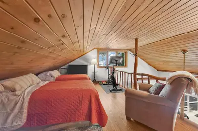 a bedroom with a bed and a wooden ceiling at Lake Wallenpaupack Lakefront Private Boat Slip in Greentown