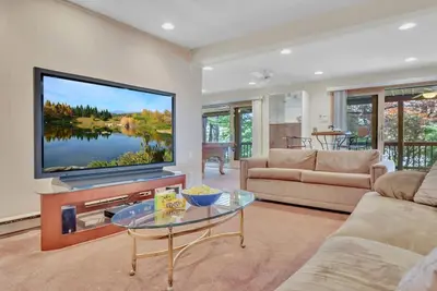 a living room with a large flat screen tv at Lakefront Views 5 Bdrm Kayaks Out Kitchen in Lake Ariel