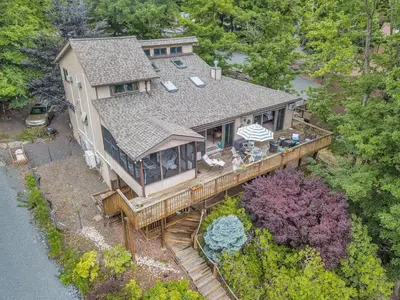 an aerial view of a house with a deck at Lakefront Views 5 Bdrm Kayaks Out Kitchen in Lake Ariel