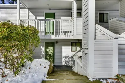 a white house with snow on the ground at All-Season Lake Wallenpaupack Condo with Views in Greentown