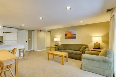 a living room with a couch and a table at All-Season Lake Wallenpaupack Condo with Views in Greentown