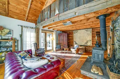 a living room with a couch and a stove at Family Cabin Near Bellayre and Plattekill Mtns! in Andes