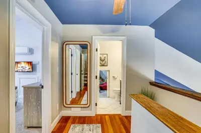 a hallway with a blue ceiling and a mirror at Lake Naomi Luxury Home with Stream Pool and Fire Pit in Pocono Pines