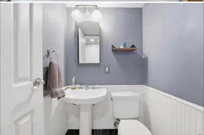 a bathroom with a white toilet and a sink at New Cozy Must Have Stay! 10 minutes to NYC in Hoboken
