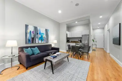 a living room with a couch and a table at Synergy Madison in New York