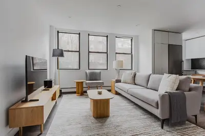 a living room with a couch and a table at Blueground Dumbo rooftop wd nr bridge NYC-1668 in Brooklyn