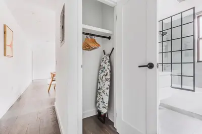 a bathroom with white walls and a sliding door at Blueground Dumbo rooftop wd nr bridge NYC-1668 in Brooklyn