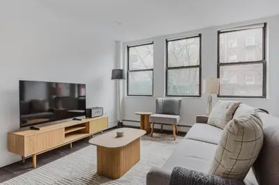 a living room with a couch and a tv at Blueground Dumbo rooftop wd nr bridge NYC-1668 in Brooklyn