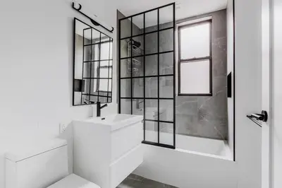 a white bathroom with a sink and a mirror at Blueground Dumbo rooftop wd nr bridge NYC-1668 in Brooklyn