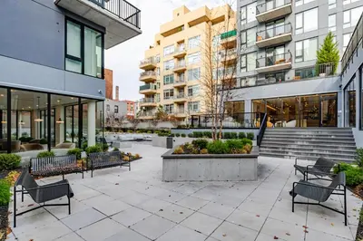 a courtyard in a building with benches and buildings at Blueground Downtown Brooklyn rooftop nr Brooklyn Bridge NYC-2186 in Brooklyn
