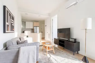 a living room with a couch and a tv at Blueground Downtown Brooklyn rooftop nr Brooklyn Bridge NYC-2186 in Brooklyn