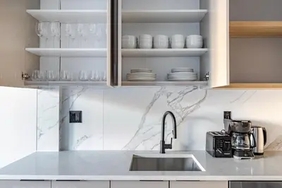 a kitchen with a sink and a counter top at Blueground Greenpoint rooftop nr Transmitter Park NYC-2196 in Brooklyn