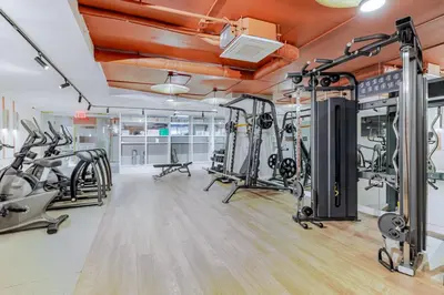 a fitness room with treadmills and cardio machines at Blueground Greenpoint rooftop nr Transmitter Park NYC-2196 in Brooklyn