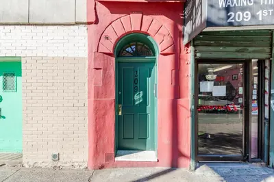 a green door on the side of a building at Blueground Greenpoint rooftop nr Transmitter Park NYC-2196 in Brooklyn