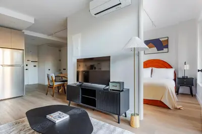 a bedroom with a bed and a table with a lamp at Blueground Greenpoint rooftop nr Transmitter Park NYC-2196 in Brooklyn