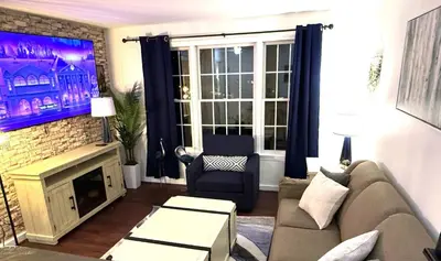 a living room with a couch and a tv at Mountain Getaway Suite Ski OnOff Jiminy Peak - Fully Redone Decor in Hancock