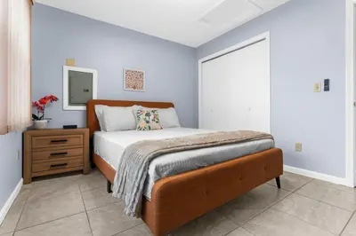 a bedroom with a bed and a dresser and a mirror at Willow Haven 2BR Cozy Retreat, Close to Hartford in Manchester