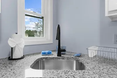 a kitchen counter with a sink and a window at Willow Haven 2BR Cozy Retreat, Close to Hartford in Manchester