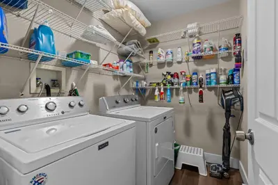 a laundry room with a washer and dryer at Evergreen Villa Poconos - Hot Tub, Fire Pit, Close to Kalahari, Great Wolf Lodge and Camelback in Tobyhanna