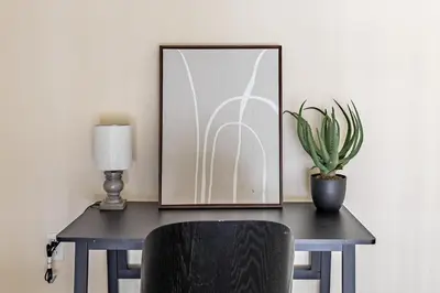 a black desk with a lamp and a plant on it at Landing Stunning 2BD Gym in New Haven