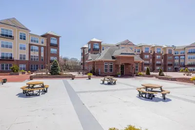 a courtyard with picnic tables in front of a building at Landing Stunning 2BD Gym in New Haven