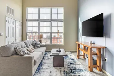 a living room with a couch and a flat screen tv at Landing Stunning 2BD Gym in New Haven