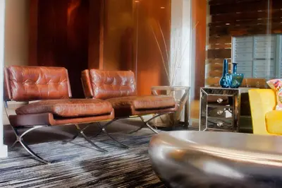 two leather chairs and a table in a room at Landing Stylish 1BD Gym Courtyard in New Haven