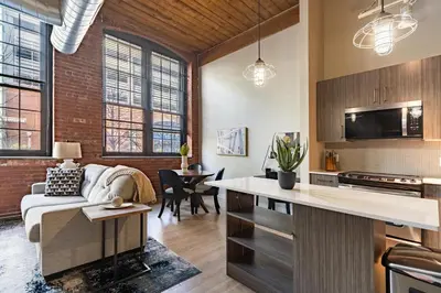 a kitchen and living room with a couch and a table at Landing Stylish 1BD Gym Courtyard in New Haven