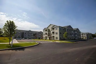 an empty parking lot in front of a apartment complex at Landing Spectacular 2BD Yoga Studio Game Room in Vernon