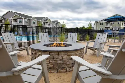 a patio with chairs and a fire pit in a yard at Landing Spectacular 2BD Yoga Studio Game Room in Vernon