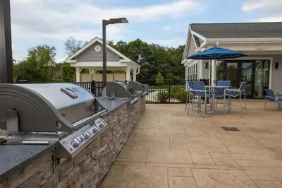 a backyard with a grill and a table and chairs at Landing Spectacular 2BD Yoga Studio Game Room in Vernon
