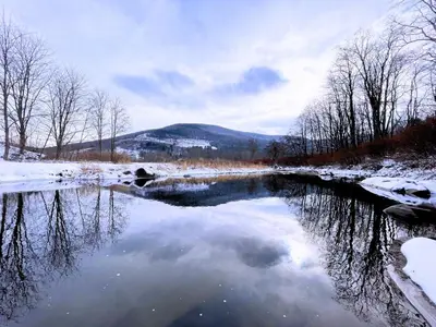 a river in the snow with a reflection of the sky at Skiing Close By! Firepit & Game Room in Ashland