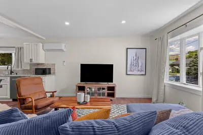a living room with a couch and a tv at Skiing Close By! Firepit & Game Room in Ashland