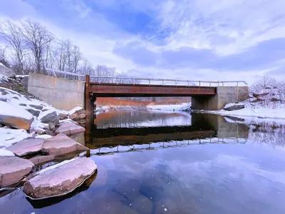 a bridge over a body of water with snow at Skiing Close By! Firepit & Game Room in Ashland