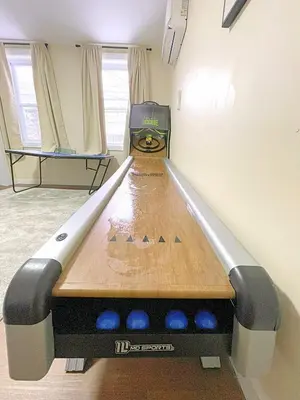 a bowling alley with a table in a room at Skiing Close By! Firepit & Game Room in Ashland