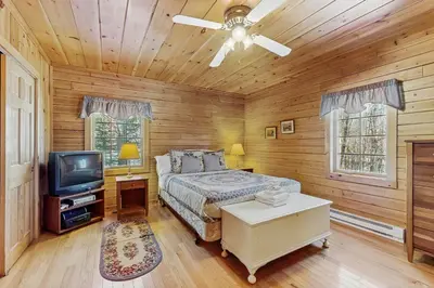 a bedroom with a bed and a tv in it at Chimney Hill Retreat in Wilmington