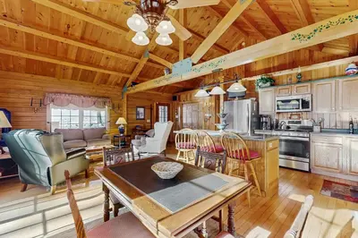 a kitchen and living room with a table and chairs at Chimney Hill Retreat in Wilmington