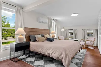a bedroom with a large bed with two lamps at Skiing Close By! Firepit & Game Room in Prattsville