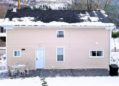 a pink house with a table and chairs in the snow at Skiing Close By! Firepit & Game Room in Prattsville
