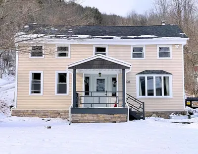 a house with a snow covered yard in front of it at Skiing Close By! Firepit & Game Room in Prattsville