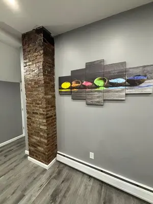 a room with four paintings on the wall at The loft 2 bedroom apartment in Newark