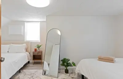 a bedroom with two beds and a mirror at Charming Entire Home,18m to Manhattan, Home Theater in Carlstadt