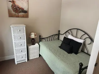 a bedroom with a bed and a dresser with a lamp at Charming Four Bedroom House in Tannersville