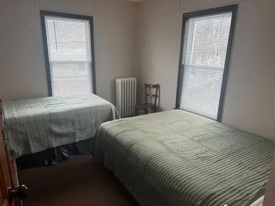 a bedroom with two beds and two windows at Charming Four Bedroom House in Tannersville